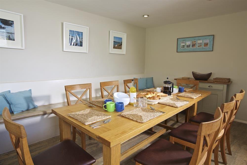Dining area with large oak table at Ferryside in East Portlemouth, Salcombe