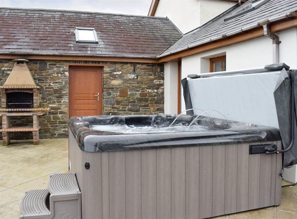 Luxurious hot tub on the paved patio at Ffynnon Meredydd Farm House in Mydroilyn, near Aberaeron, Ceredigion., Dyfed