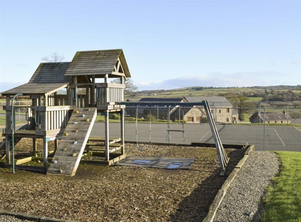 Tennis court and children’s play area at Ffynnon Meredydd Farm House in Mydroilyn, near Aberaeron, Ceredigion., Dyfed