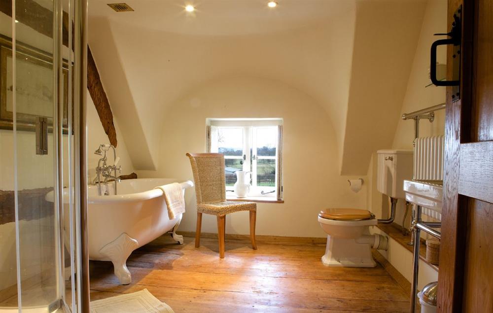 First floor, Bathroom with a roll top bath, separate shower and heated towel rail at Field Cottage and Garden Room, Elmley Castle, Pershore