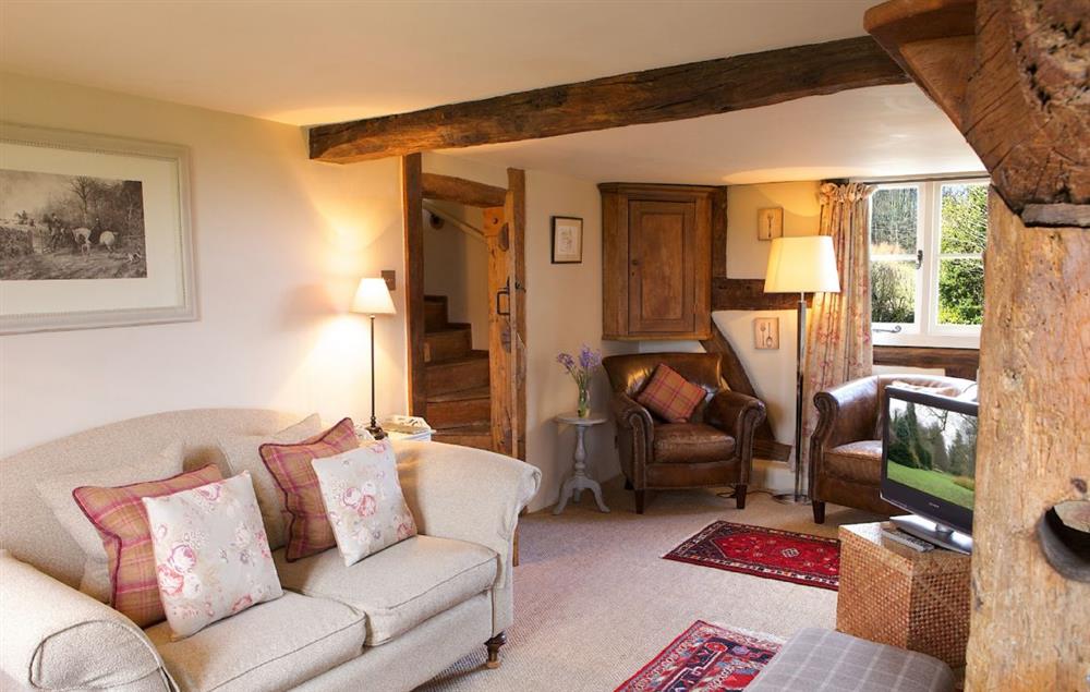 Cosy sitting room with wood burning stove (photo 2) at Field Cottage, Elmley Castle