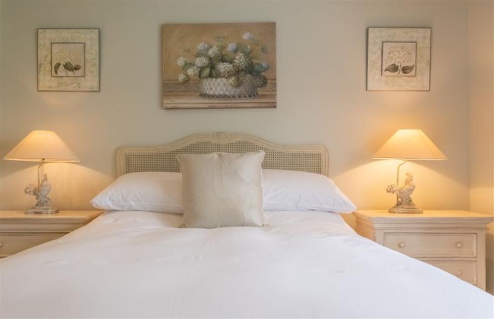 Bedroom one with 5’ king-size bed at Field Piece Cottage, Burnham Market