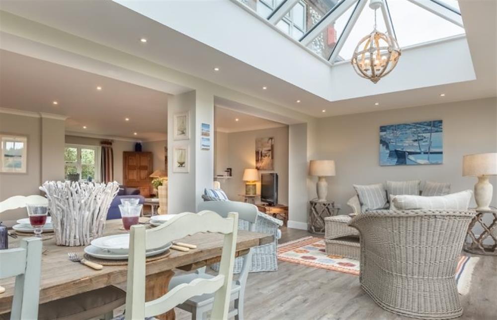 The dining area leads through to the sitting areas  at Field Piece Cottage, Burnham Market