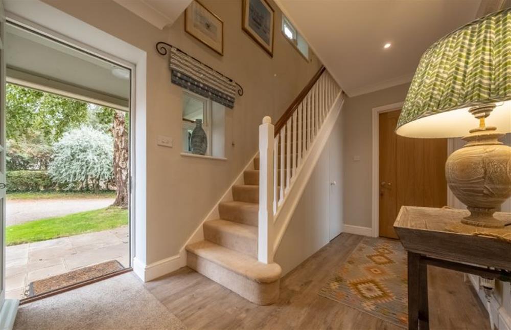 The spacious entrance hall with stairs leading to the first floor at Field Piece Cottage, Burnham Market
