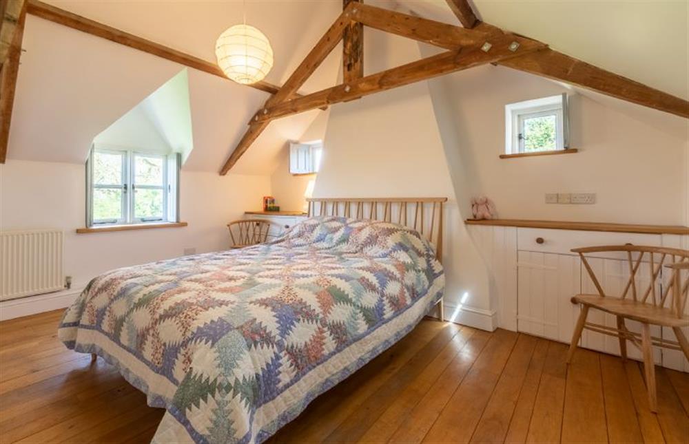 First floor: The spacious master bedroom has a king-size bed at Field Row, Field Dalling near Holt