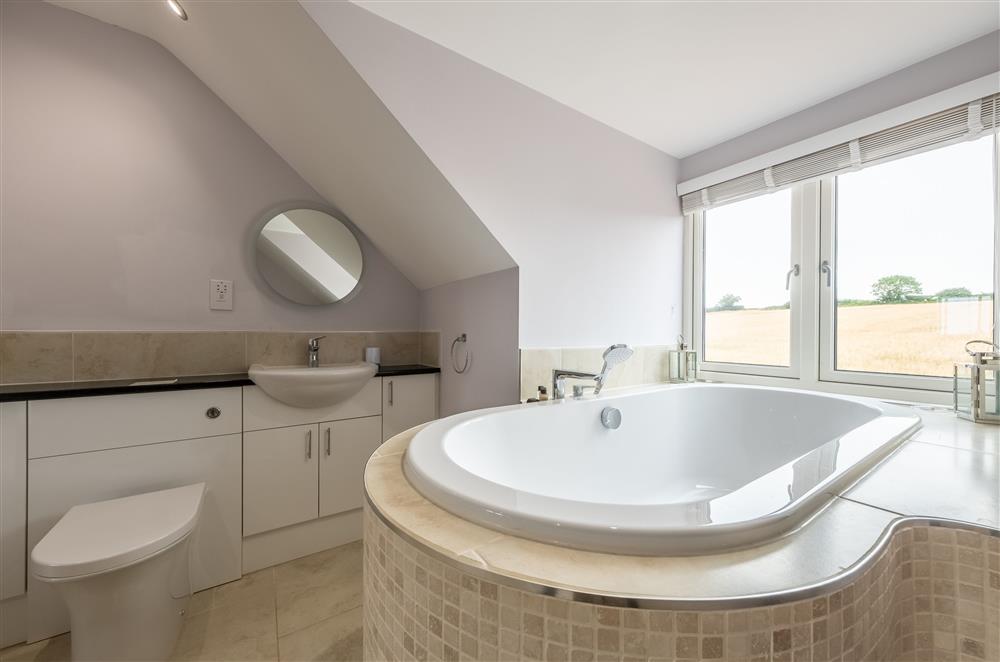 En-suite to bedroom one with free-standing bath with a view at Field View, Sedgeford