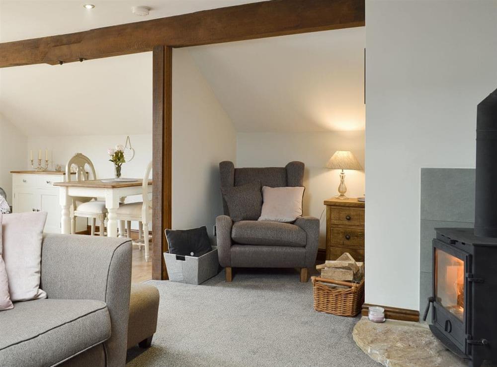 Cosy open-plan living area with wood burner at Fields Farm Apartment in Peak Forest, near Buxton, Derbyshire