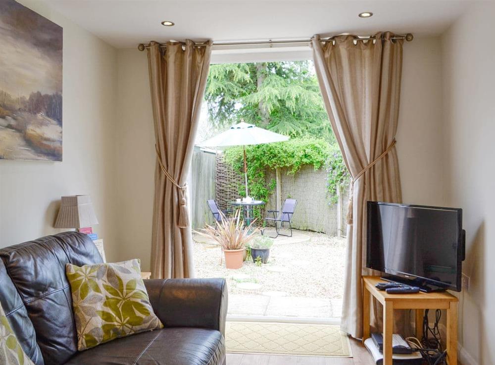 Cosy living area with doors to the patio area at Fieldview Cottage in Bruisyard, near Framlingham, Suffolk