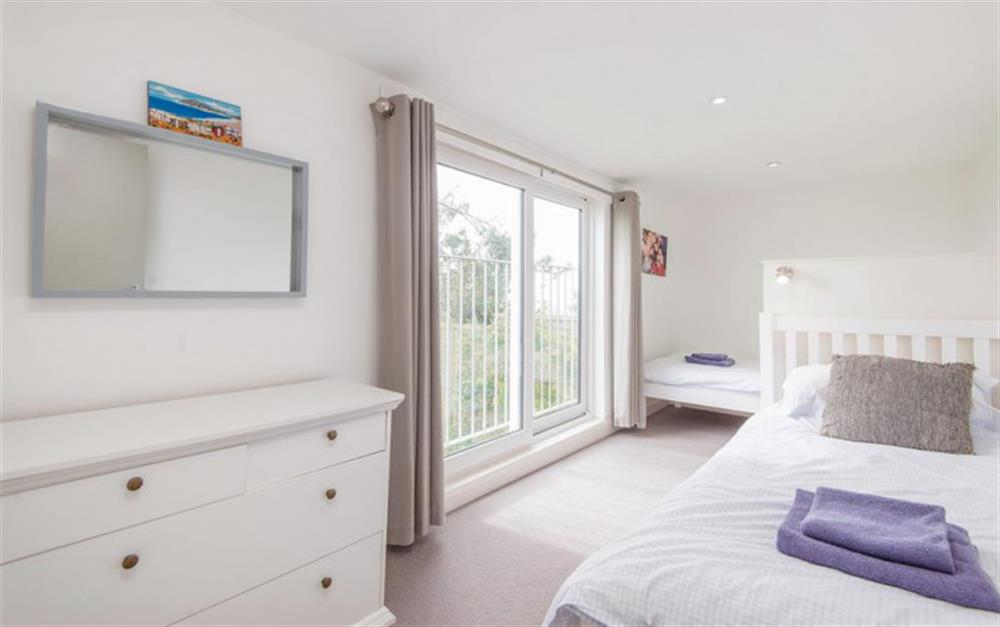 The second twin bedroom, adjacent to the utility area with sliding glazed doors & juliet balcony at Fiferail in Thurlestone