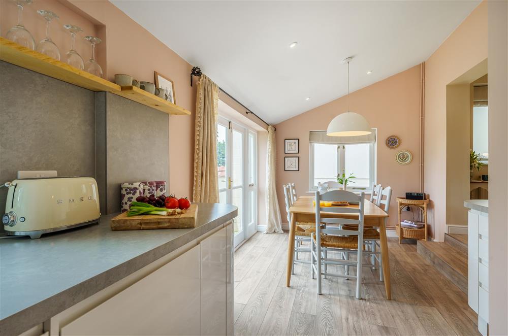 The open-plan dining area sits next to the kitchen at Fig and Bay Cottage, Axminster