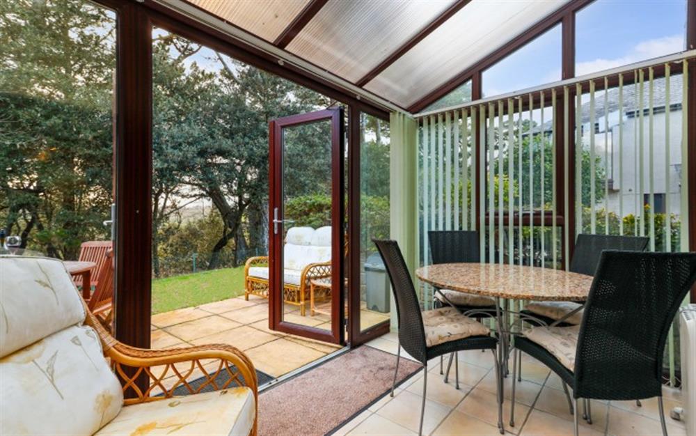 The conservatory adds another room - a place to eat, play family games, or simply relax in the armchair. at Finders, 87 Keeper's Cottage in Maenporth