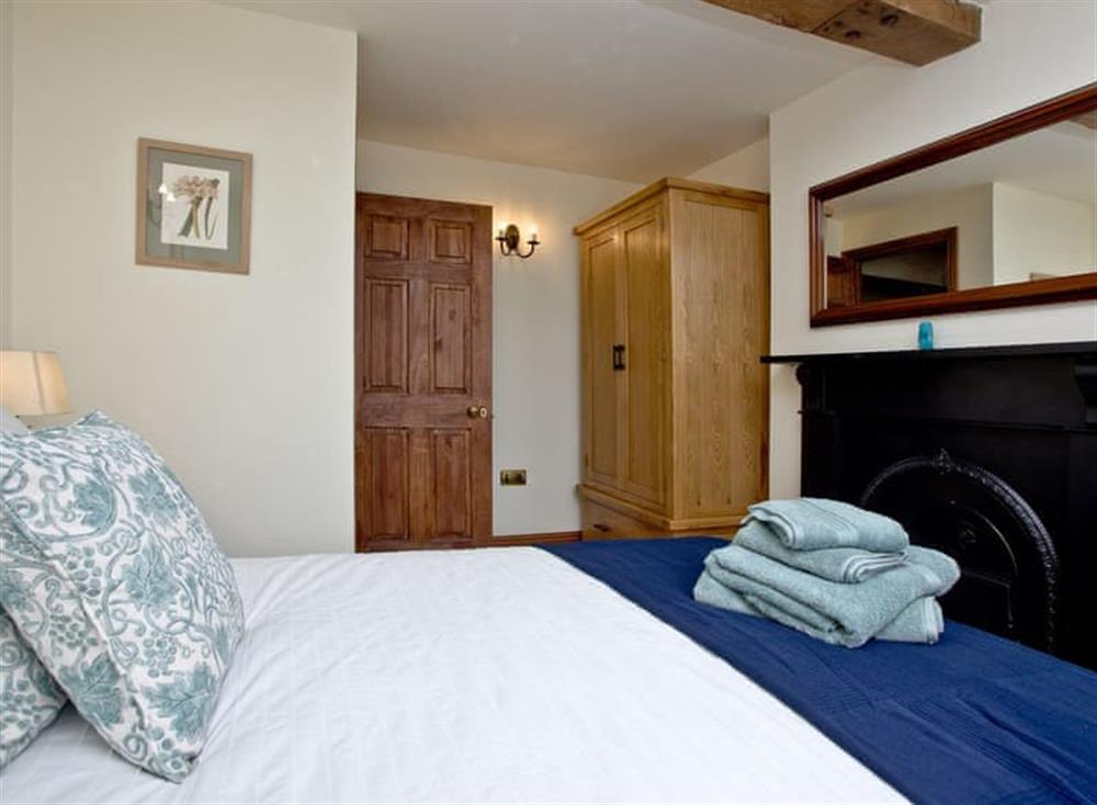 Comfortable double bedroom with feature fireplace at Firestone Lodge in , Wootton