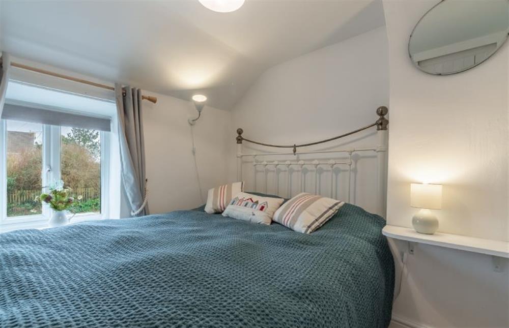 First floor: Bedroom one with king-size brass bed at First and Last, Trimingham near Norwich