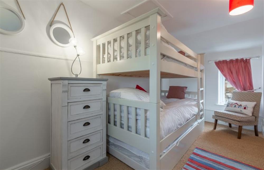 First floor: Bedroom two with full-size wooden bunk beds at First and Last, Trimingham near Norwich
