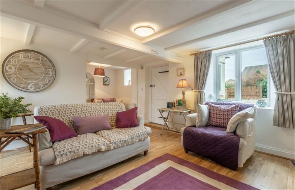 Ground floor: Sitting room with beamed ceilings and comfy sofas at First and Last, Trimingham near Norwich