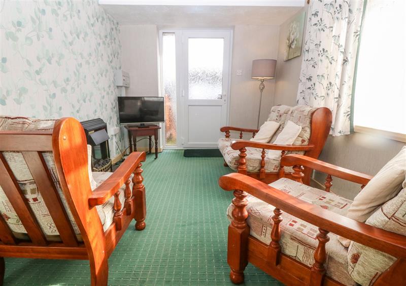 Relax in the living area at First Floor Apartment, Tremadog