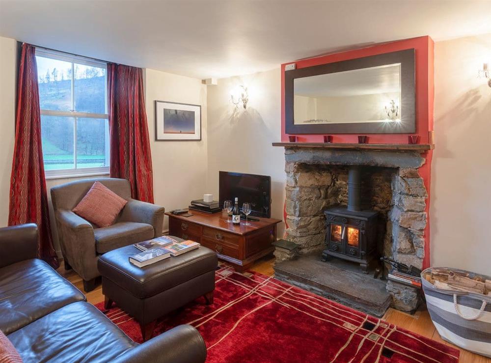 Relaxing living room with wood burner at Fisher Place in Thirlmere, near Keswick, Cumbria