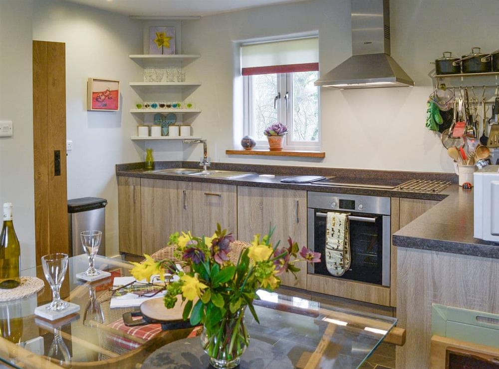 Well-equipped fitted kitchen with convenient dining area at Fishermans Nook in Dartmeet, near Yelverton, Devon, England