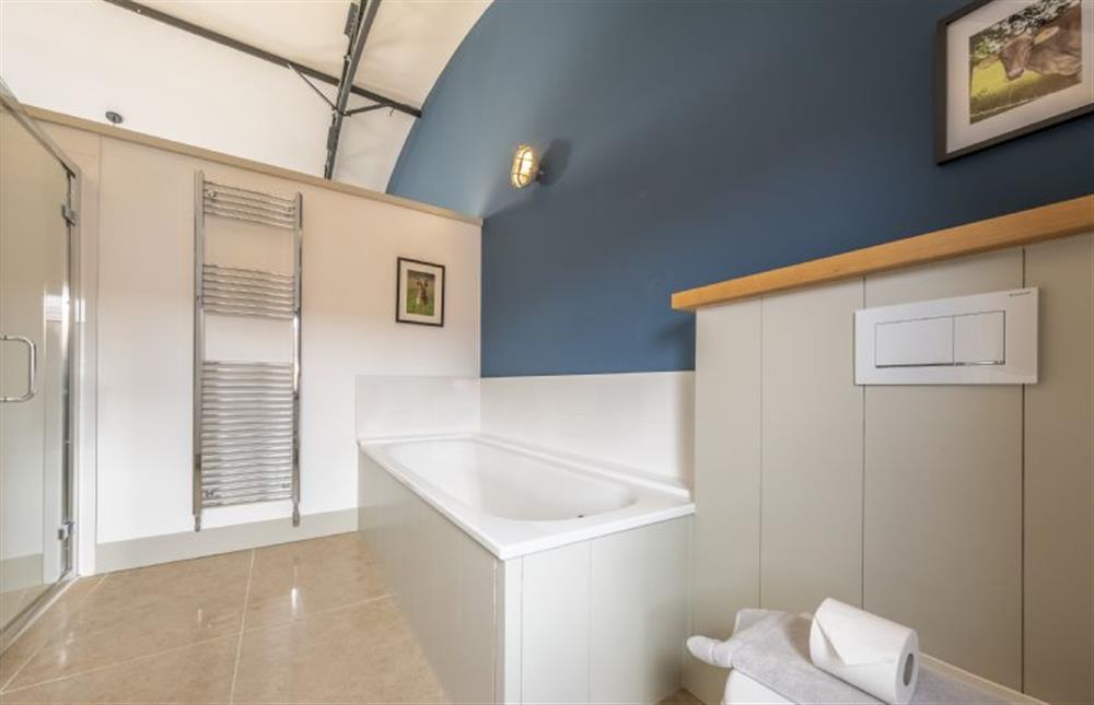 Master bedroom en-suite, with large bath and walk-in shower at Fitters Barn, Warham