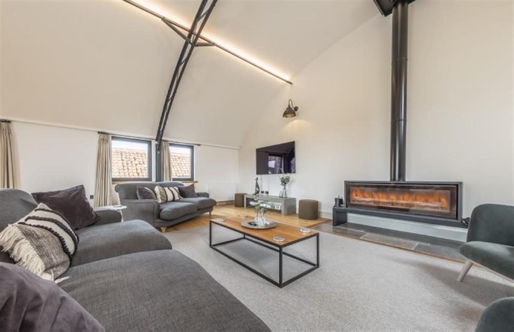 Unique and incredibly stylish sitting room with large Smart television and feature wood burning stove