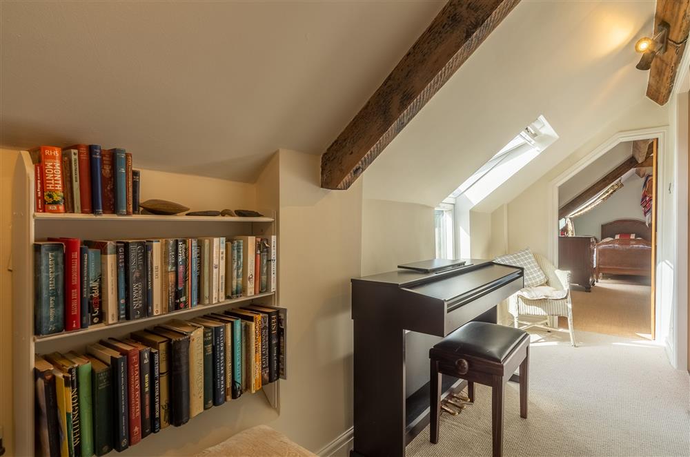Hallway with books and piano at Five Acres, Boltby