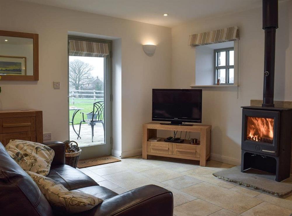 Cosy living room with wood burner at Five Barred Gate Barn in Whitechapel, near Goosnargh, Lancashire