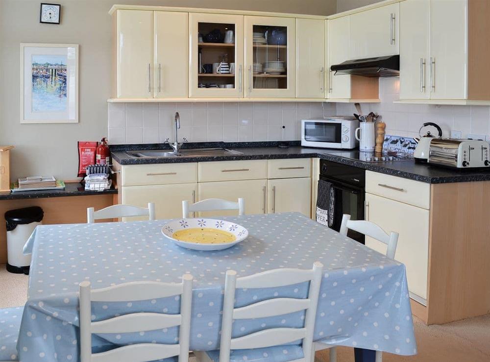 Dining and adjacent kitchen area at Flat 10 in Coverack, near Helston, Cornwall