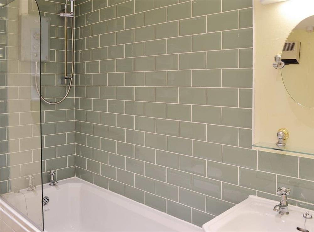 Tiled bathroom with shower over the bath at Flat 10 in Coverack, near Helston, Cornwall