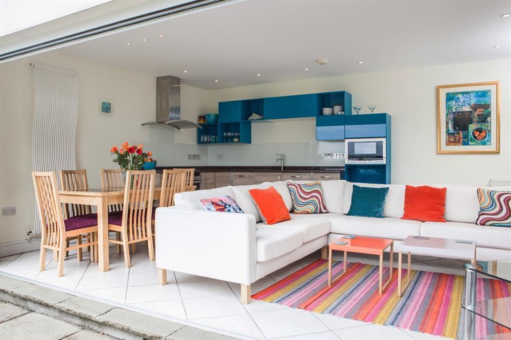 Sitting area with folding doors leading out to the sun terrace at Flat 3 Albany House in Allenhayes Road, Salcombe