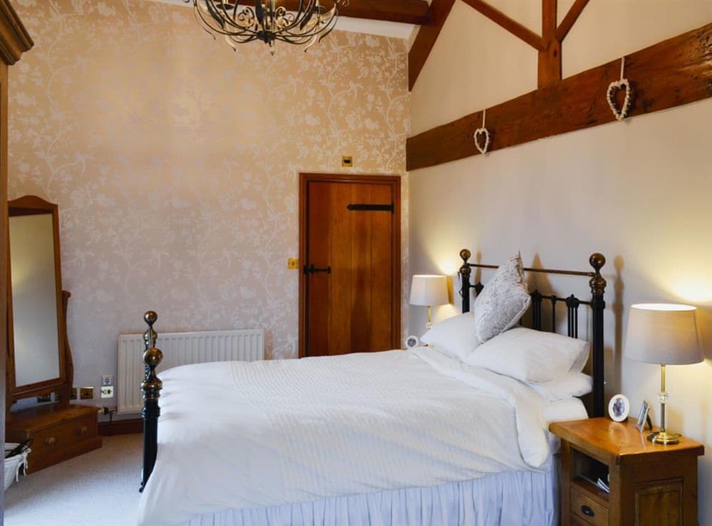 Comfortable bedroom with kingsize bed and en-suite shower room at Flatts Barn in Hebden, near Grassington, North Yorkshire