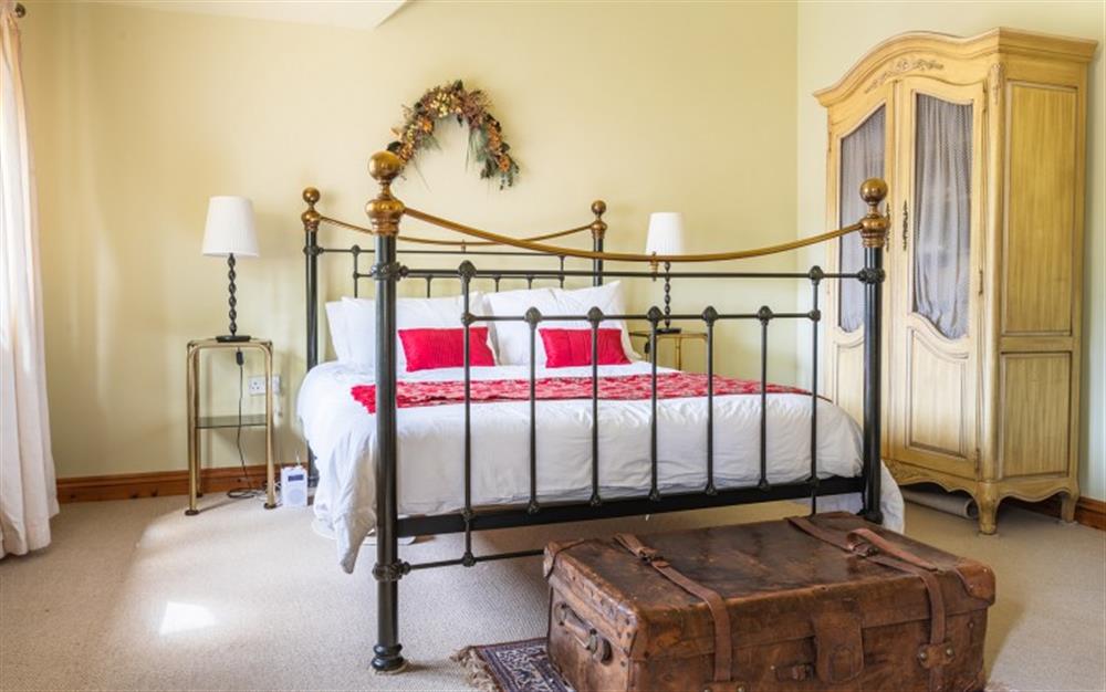 Master bedroom with king size bed at Flax Cottage in Waytown