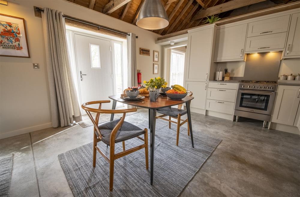 The kitchen and dining area with seating for two guests at Flittermouse Barn, Hornsea