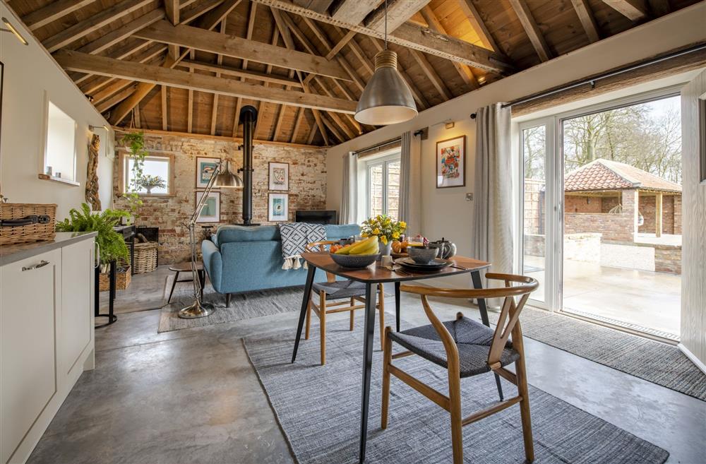 The open-plan living area boasts exposed beams at Flittermouse Barn, Hornsea