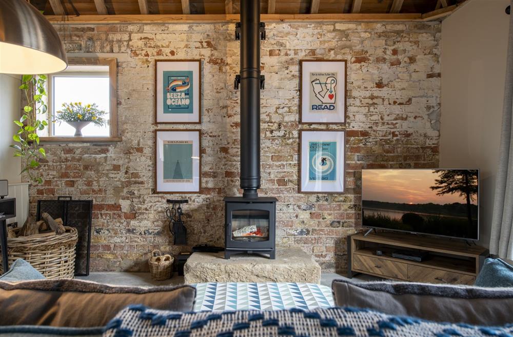 The sitting room with exposed brick work and Smart television at Flittermouse Barn, Hornsea