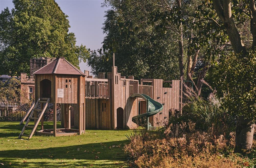 The playground with a climbing wall and slide