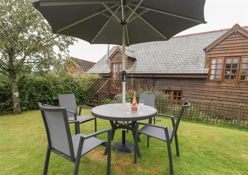 Enjoy a glass of wine on the patio at Floras Barn, Crowcombe