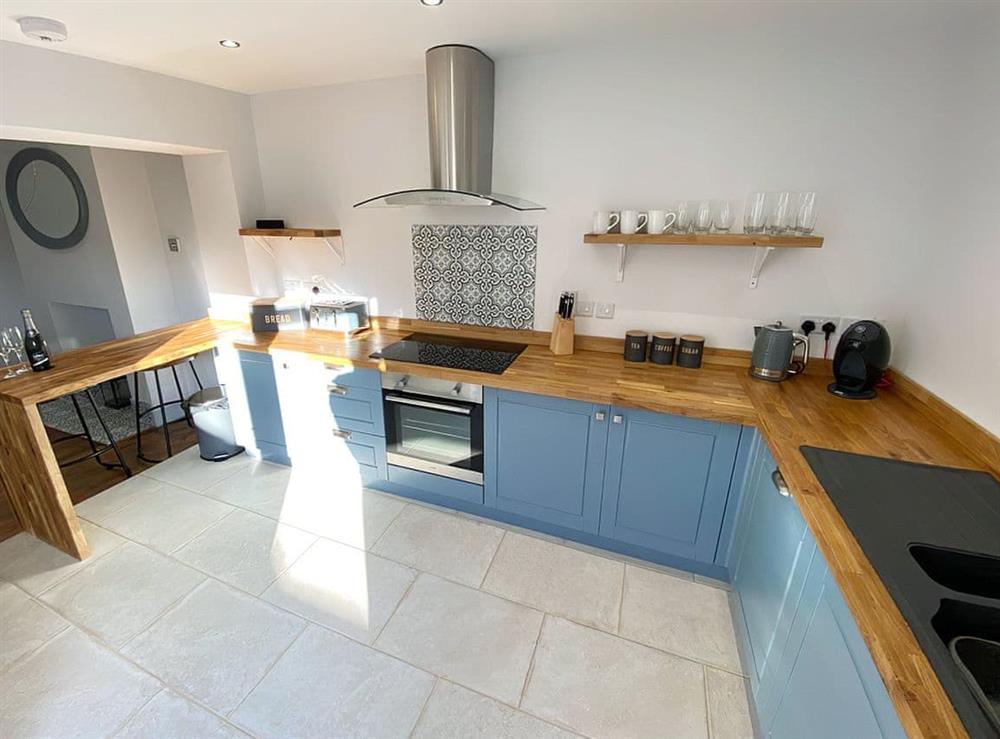 Shaker-style kitchen with breakfast bar at Florence Cottage in Hunstanton, Norfolk
