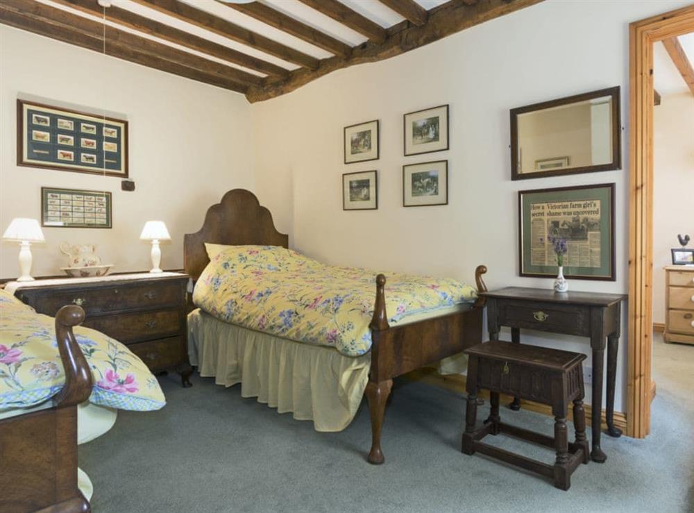 Comfortable twin bedroom at Flowers Barn in Middle Duntisbourne, near Cirencester, Gloucestershire