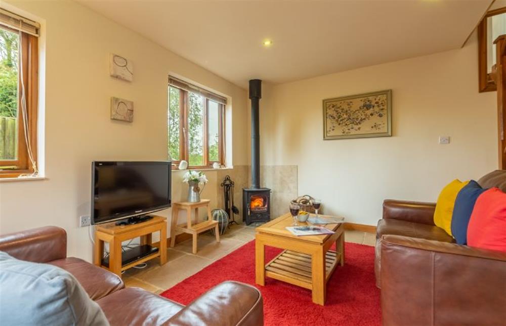 Ground floor: Cosy sitting room with wood burning stove, perfect for cosy winter nights at Focsle, Wiveton  near Holt