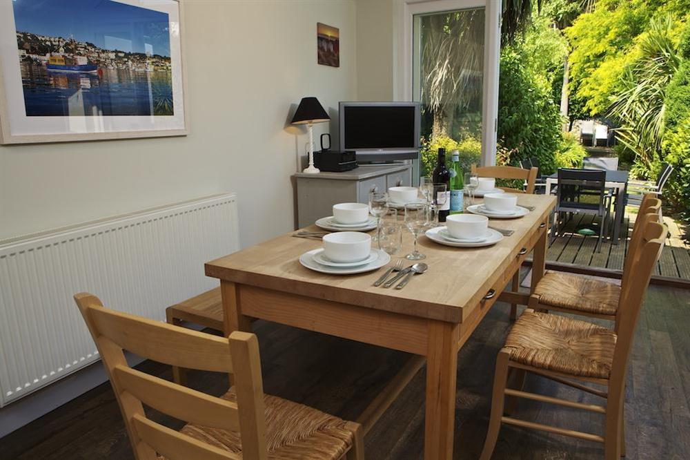 Dining area with French doors out to decking and garden at Fordlea in , Salcombe