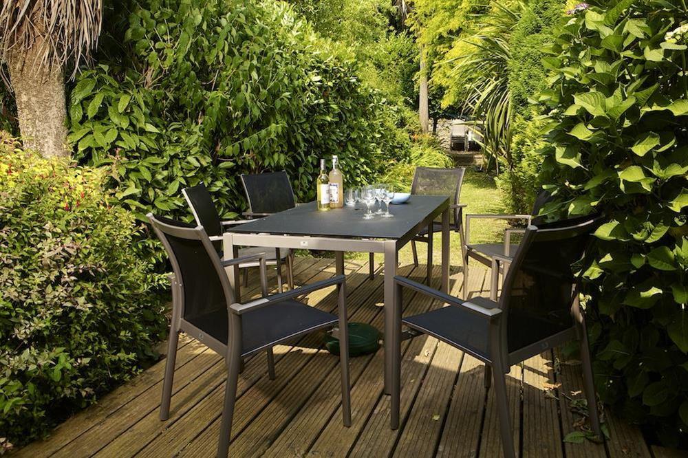 Good sized decking area with table, parasol and chairs