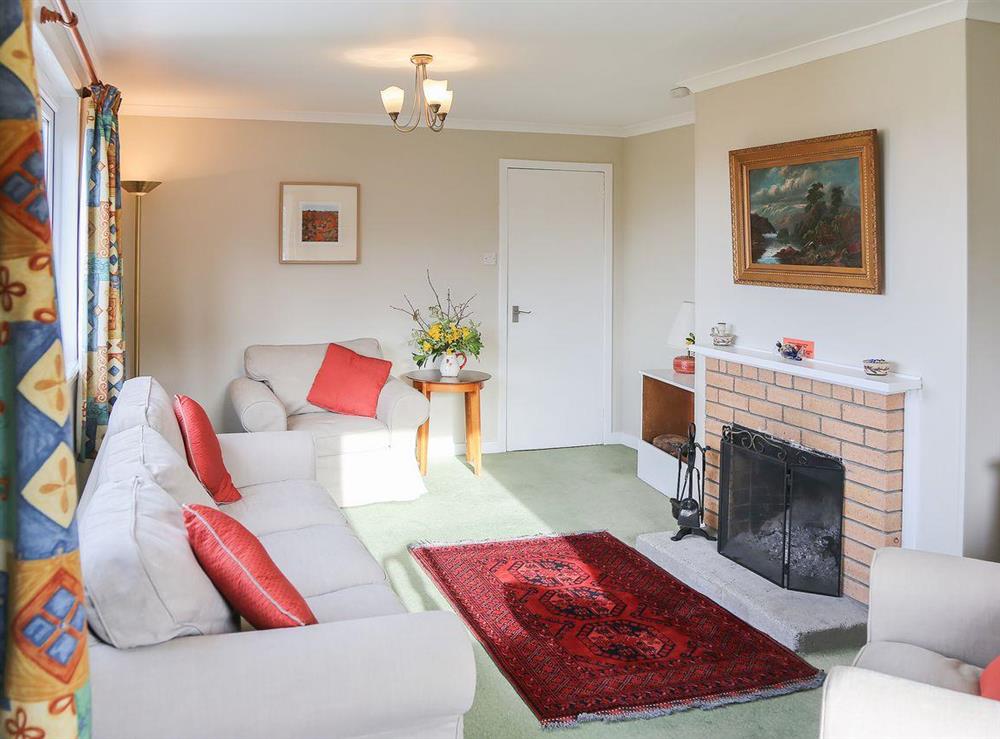 Lovely living room with open fireplace at Forest Cottage in Ardmaddy Castle, Nr Oban, Argyll., Great Britain