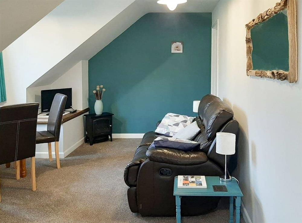 Lovely living area with dining table and chairs at Forge Cottage in Shaldon, Devon