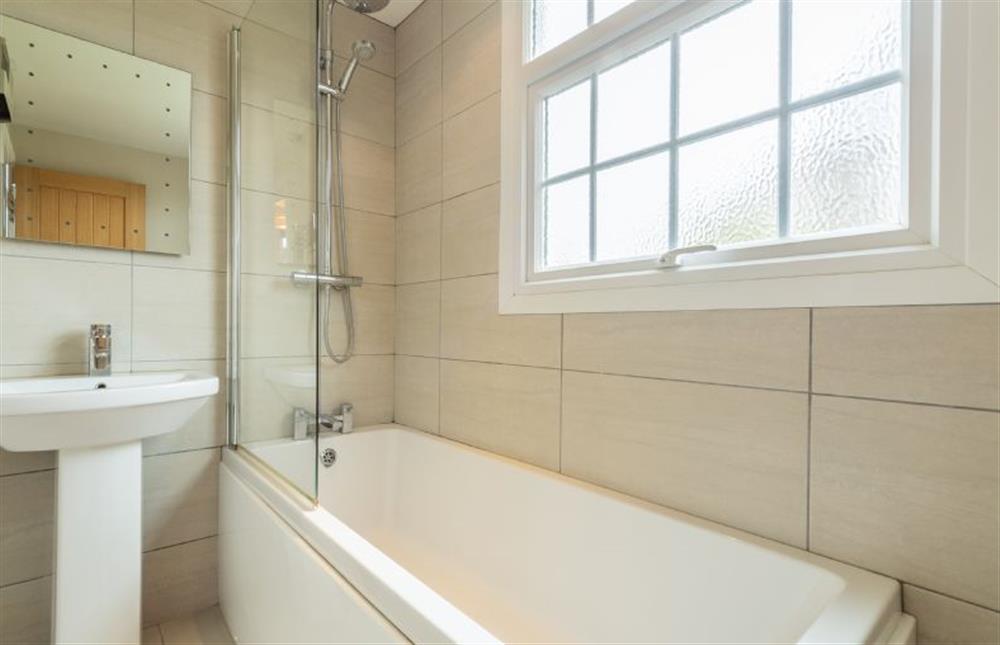 First floor:  Bathroom with bath with rainfall shower over at Forge Cottage, Thornham near Hunstanton