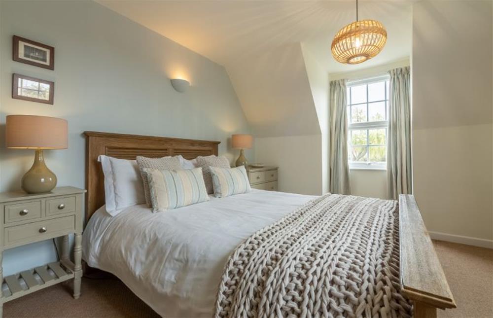 First floor:  Master bedroom with king size bed at Forge Cottage, Thornham near Hunstanton
