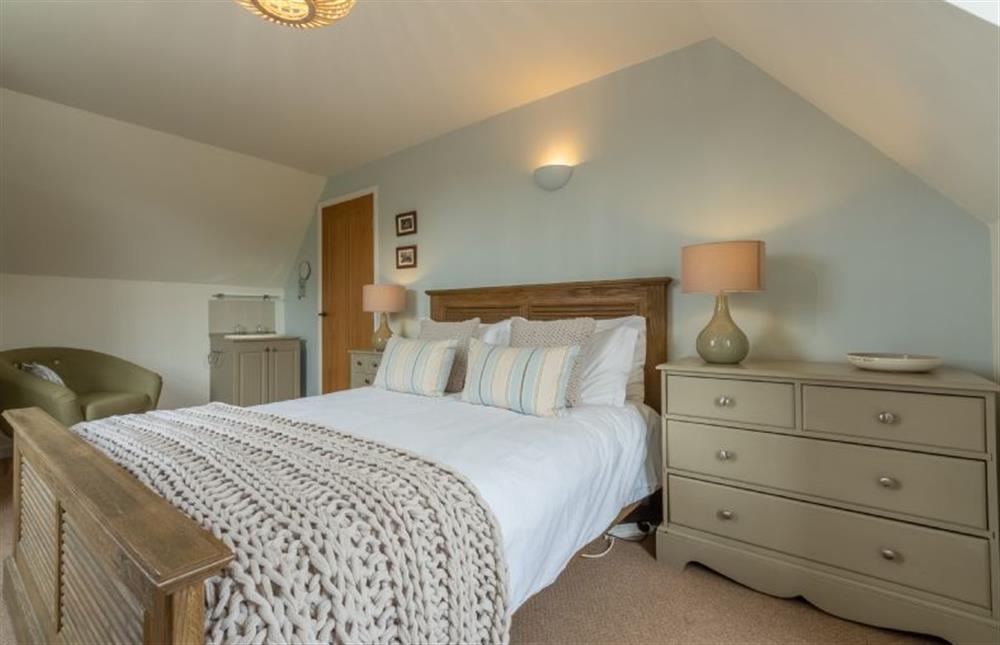 First floor:  Master bedroom with sloping ceiling at Forge Cottage, Thornham near Hunstanton