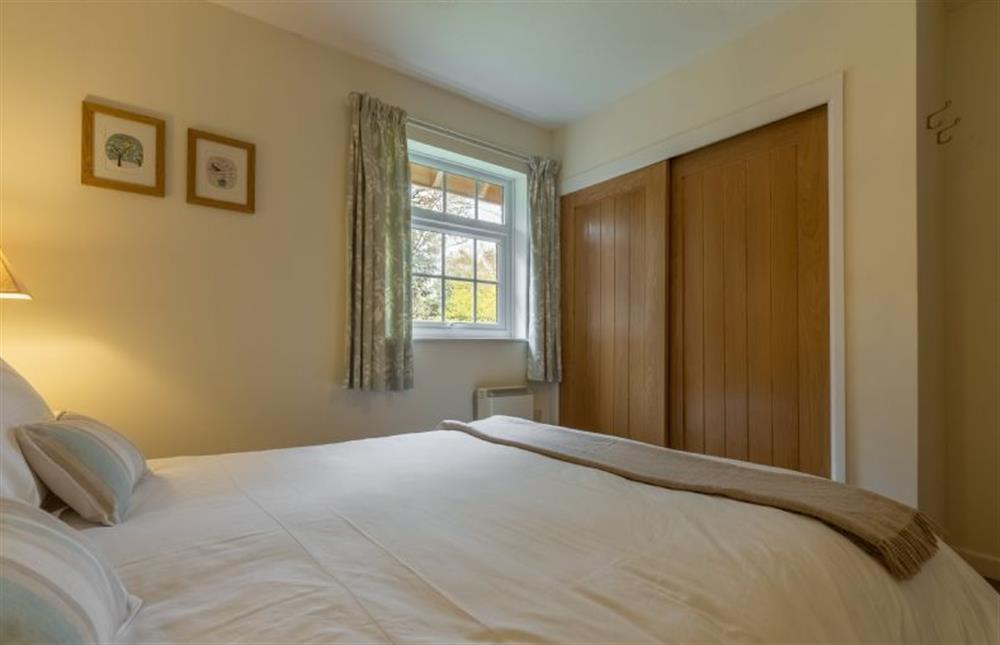 Ground floor: Bedroom three with double bed and built in wardrobe at Forge Cottage, Thornham near Hunstanton