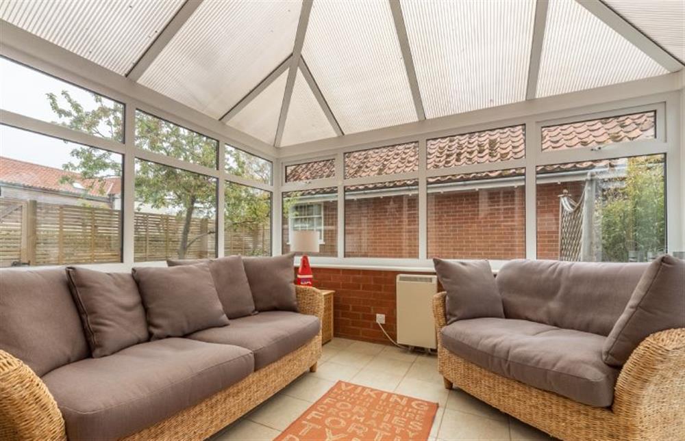 Ground floor: Conservatory with comfortable seating (photo 2) at Forge Cottage, Thornham near Hunstanton