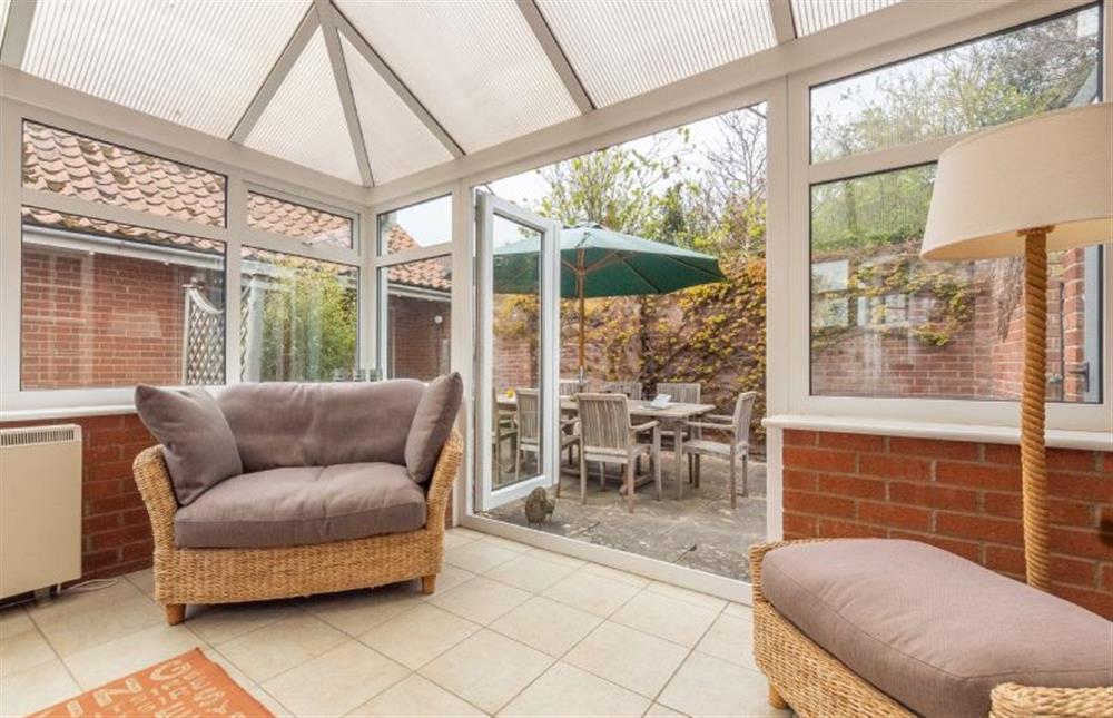 Ground floor: Conservatory with comfortable seating at Forge Cottage, Thornham near Hunstanton