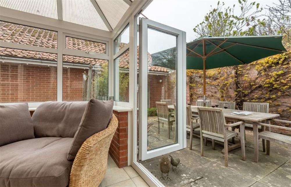 Ground floor: Conservatory with double doors leading into the garden at Forge Cottage, Thornham near Hunstanton